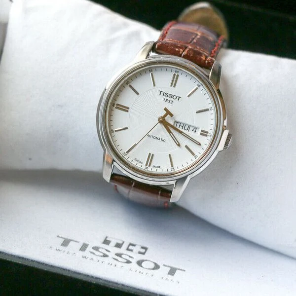 8c7cccce-9aa2-4ad6-b6f6-9be2a1736040 Tissot Automatics III Steel White Dial Brown Leather Strap Watch For Men - T065.430.16.031.00