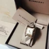 1f576efb8dcb8b0991a653fb0e994f92-833702_d223c800-c4d1-4dbb-8074-8546d385f353 Burberry Nova Gold Tone Square Dial Leather Strap Watch for Women - BU1582