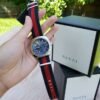 e5a99ea50cac1457ffb313f3b78da679-373651_51c8ecb4-fe40-4133-a1e5-da9d6ce27bcb Gucci GG2570 Quartz Blue Dial Blue & Red Nylon Strap Watch For Men - YA142304