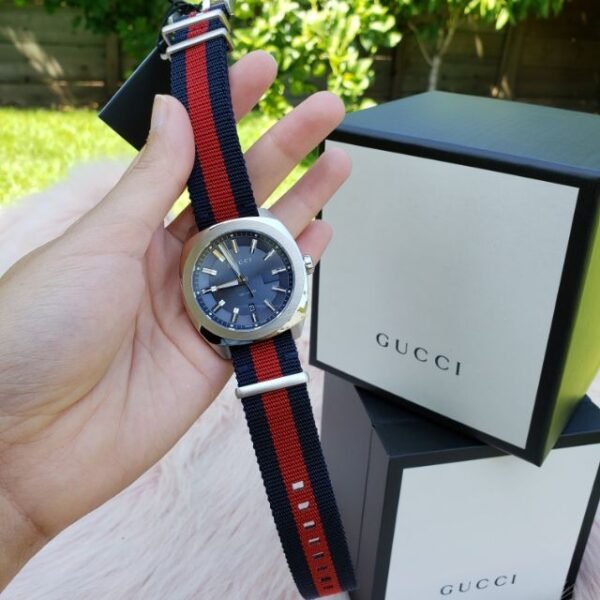 e5a99ea50cac1457ffb313f3b78da679-373651_51c8ecb4-fe40-4133-a1e5-da9d6ce27bcb Gucci GG2570 Quartz Blue Dial Blue & Red Nylon Strap Watch For Men - YA142304