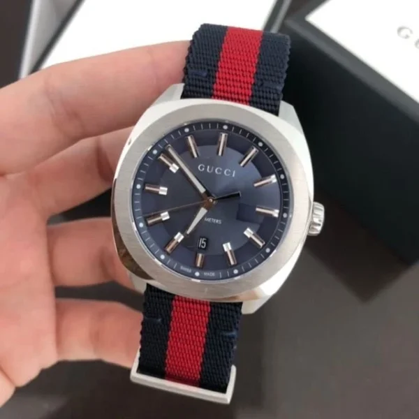 f3c1ce33f876c0d28eb38a2b8228f027-103134_5bcc5831-d4e1-43cb-b5ec-e64429d33f5f Gucci GG2570 Quartz Blue Dial Blue & Red Nylon Strap Watch For Men - YA142304
